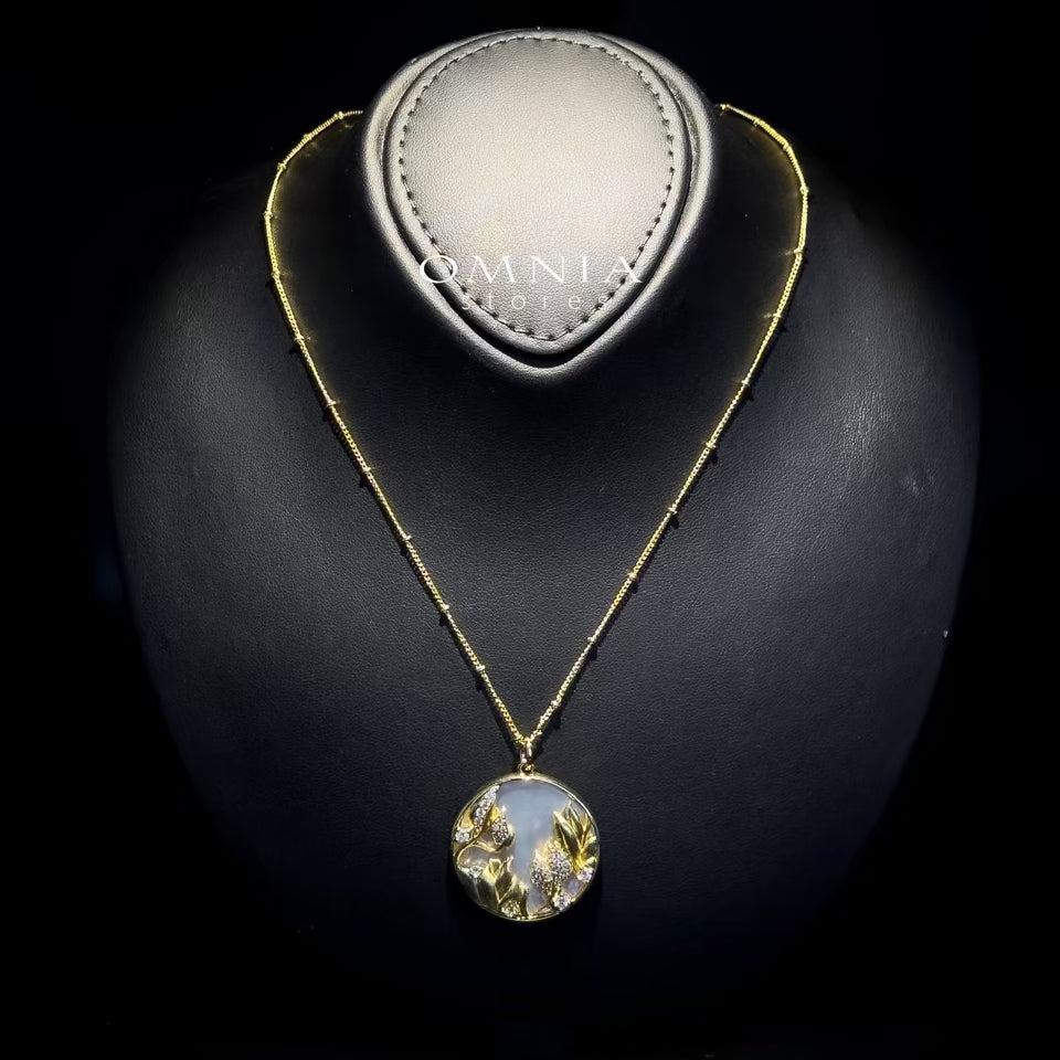 Omnia Aurelia White Shell Mother of Pearl Round Pendant Necklace with Floral Zircon Accents in Brass with Gold Plated Finish - OMNIASTORES UAE